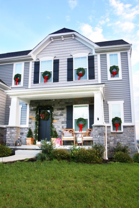 Uniform Wreath Placement Creates a Festive Facade — Christmas Window Wreaths