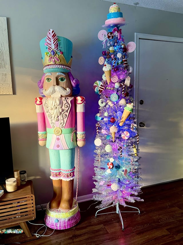 Oversized Pastel Nutcracker Beside a Tinsel Candy Tree Oversized Pastel Nutcracker Beside a Tinsel Candy Tree — Nutcracker Christmas Tree