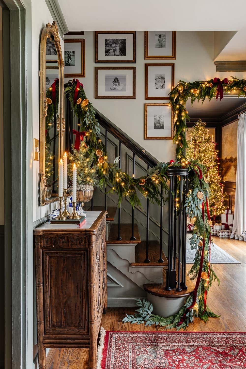 Garland with Lights and Dried Oranges, Reflected in an Ornate Mirror Garland with Lights and Dried Oranges, Reflected in an Ornate Mirror — Christmas Staircase Decor