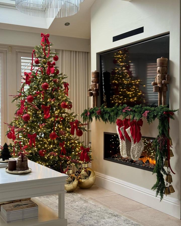 Corner Christmas Tree Next to a Stocking-Adorned Fireplace — Red and Gold Christmas Tree