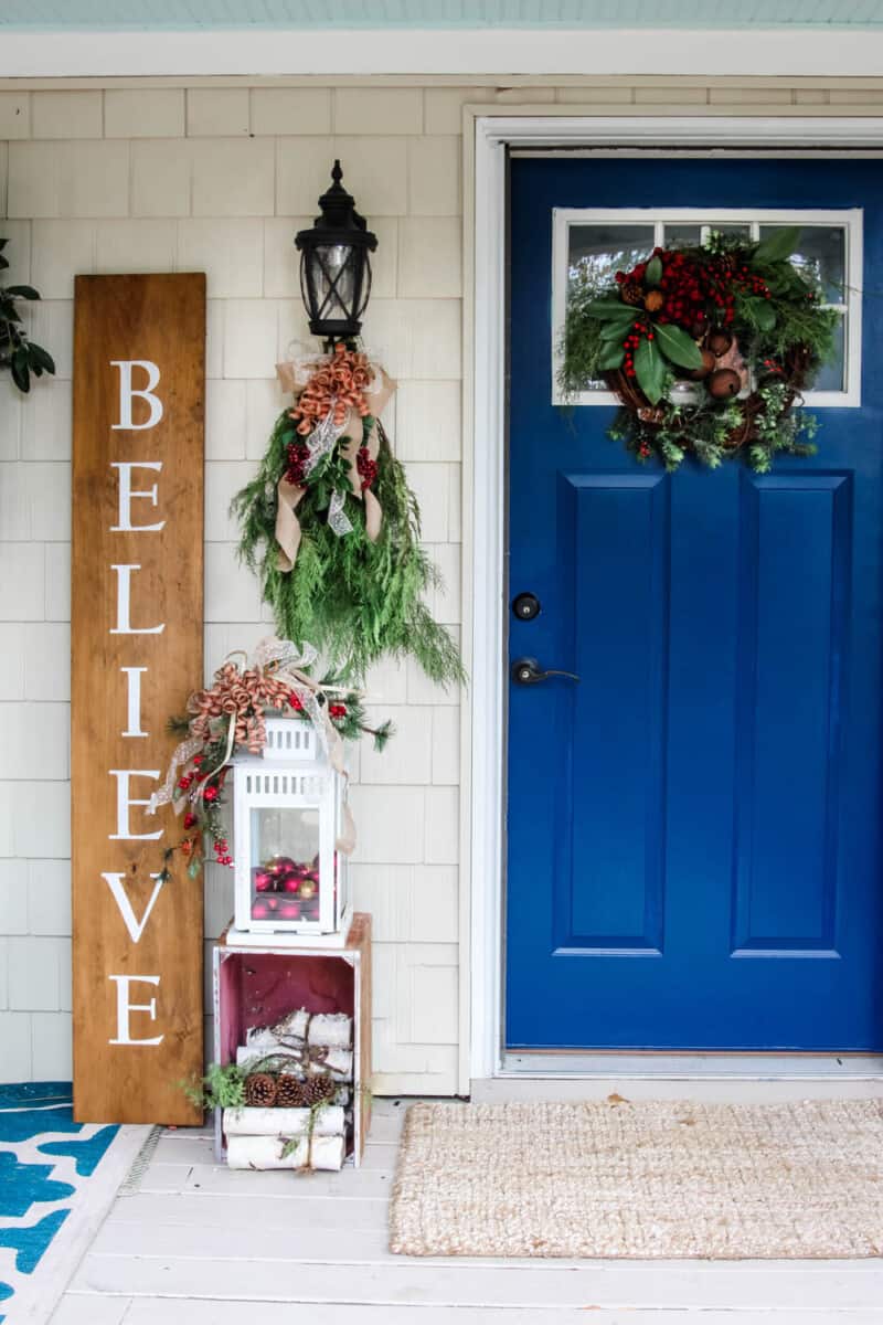 Modern Farmhouse Porch with Vibrant Door and 'Believe' Sign Modern Farmhouse Porch with Vibrant Door and 'Believe' Sign — Small Christmas Porch