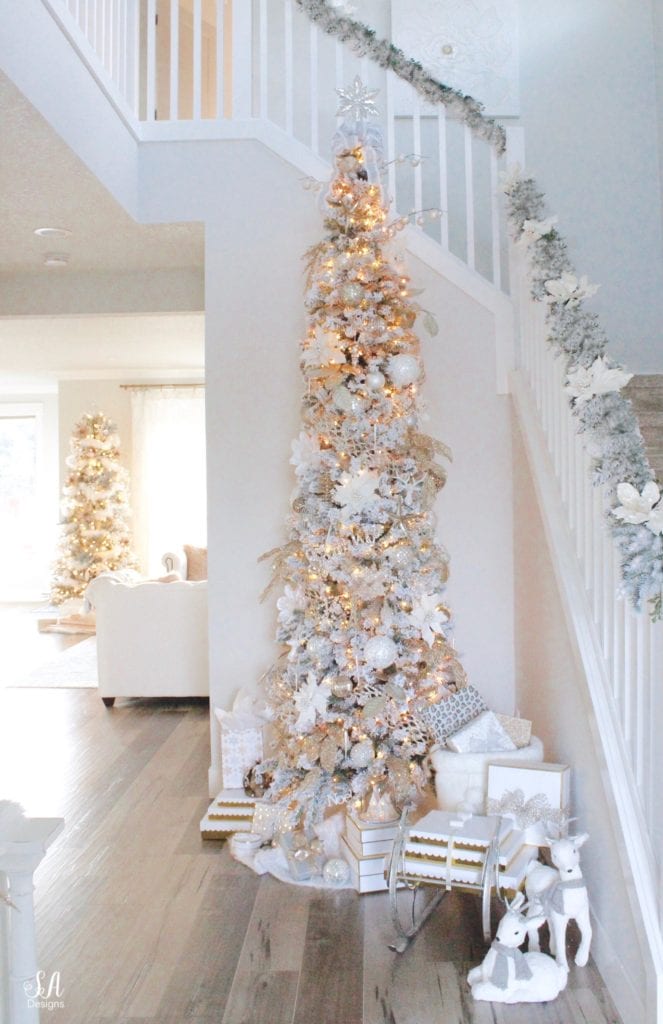 Elegant Slim Tree at the Base of a White Staircase — Slim Christmas Tree Decor