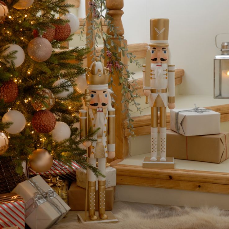 Elegant White and Gold Nutcracker Figures by a Staircase Elegant White and Gold Nutcracker Figures by a Staircase — Nutcracker Christmas Tree