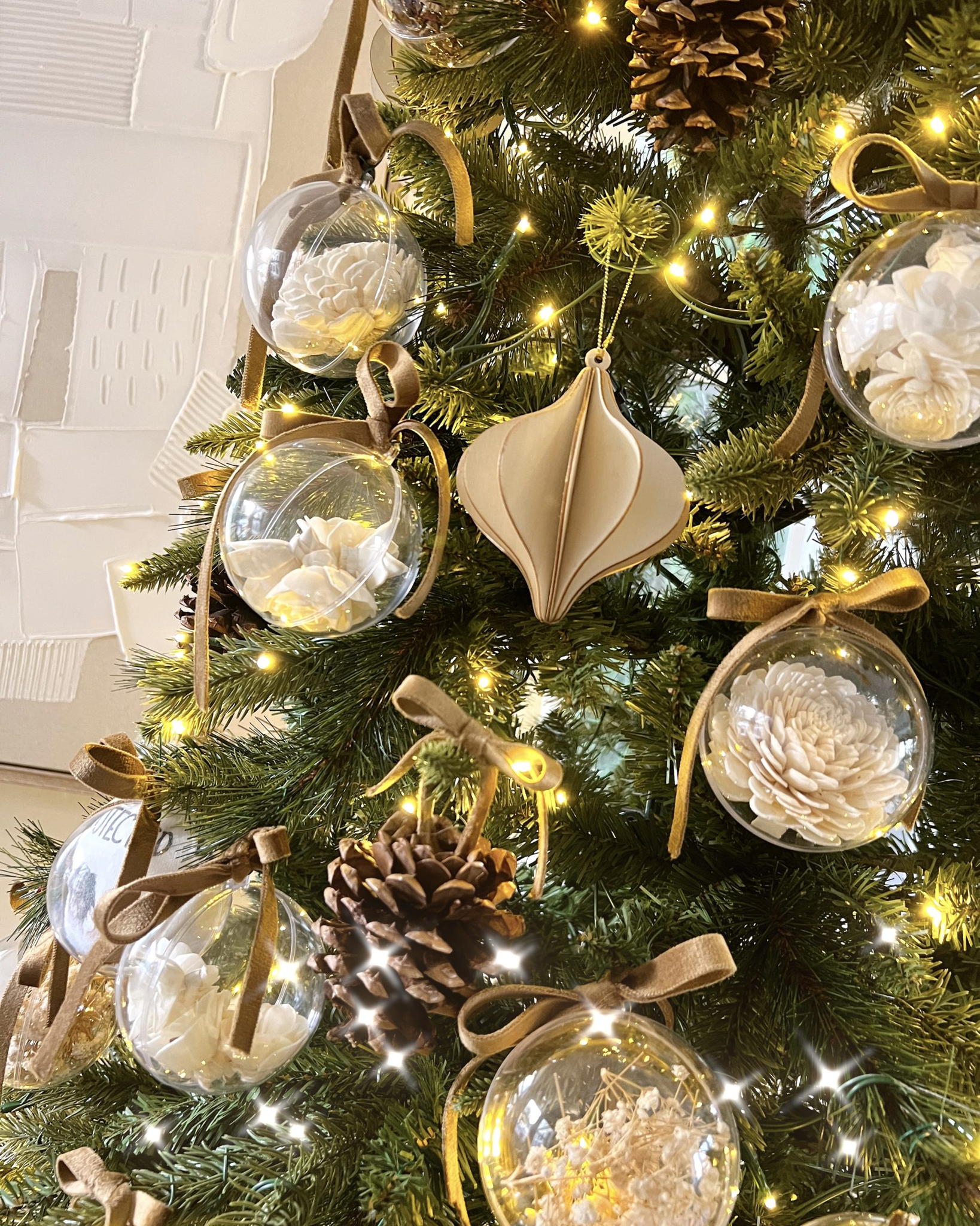 Clear Ornaments with Dried Flowers on a Neutral Christmas Tree