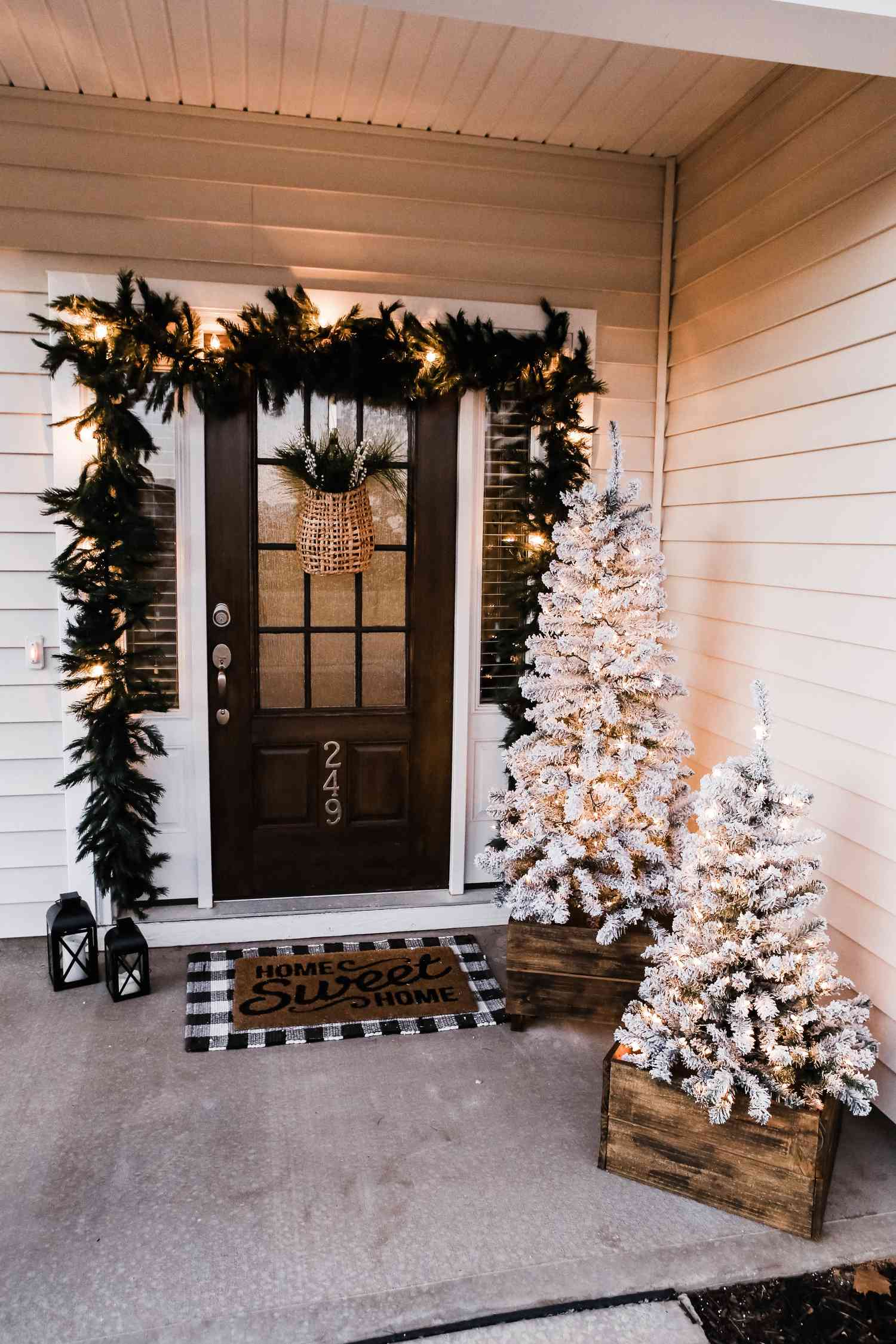 Modern Farmhouse Porch with Flocked Trees and Garland Lights Modern Farmhouse Porch with Flocked Trees and Garland Lights — Outdoor Christmas Lights