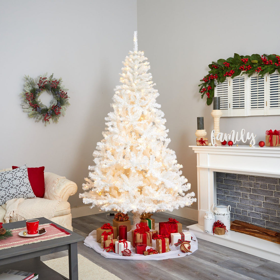 Spacious Living Room with a Large White Christmas Tree by the Fireplace Spacious Living Room with a Large White Christmas Tree by the Fireplace — White Christmas Tree Decor