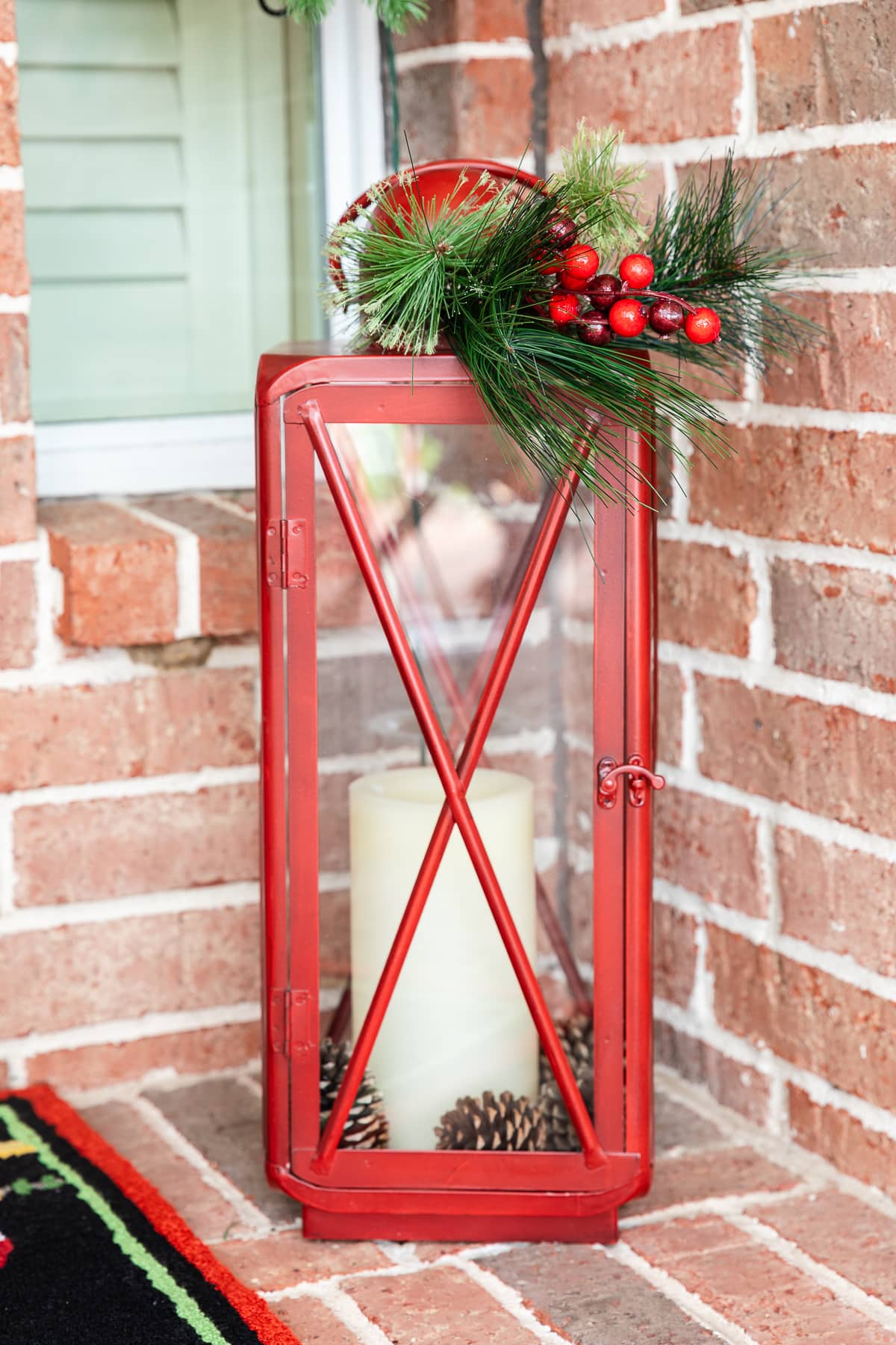 Vibrant Red Metal Lantern with Pillar Candle and Natural Greenery — Christmas Porch Lanterns