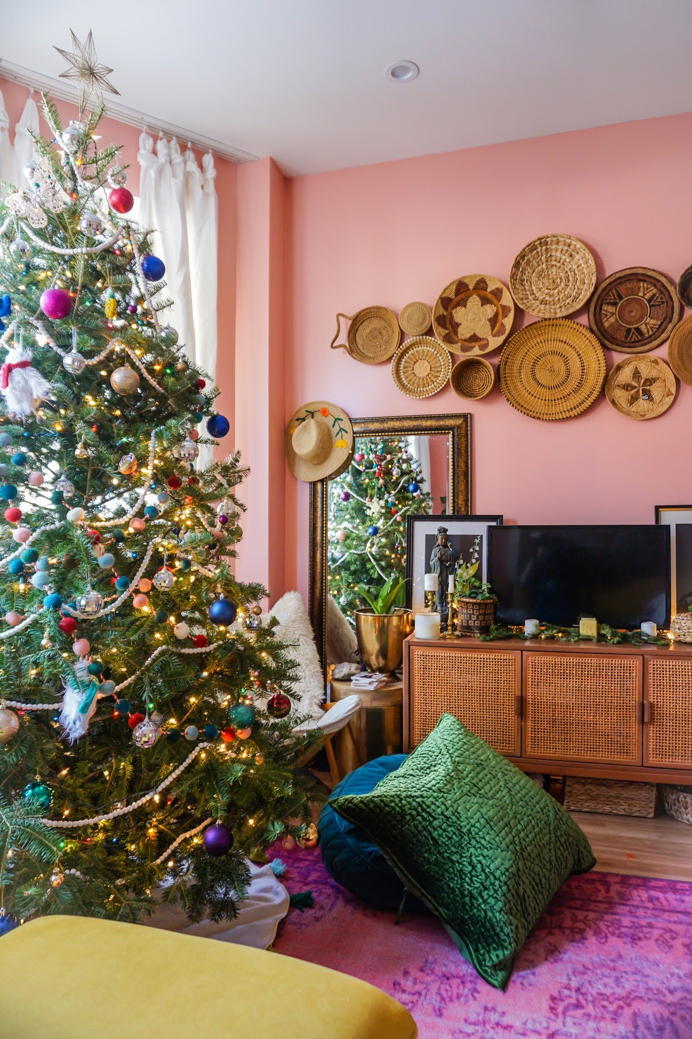 Eclectic Boho Christmas Tree with Pink Walls and Wicker Accents — Boho Christmas Decor