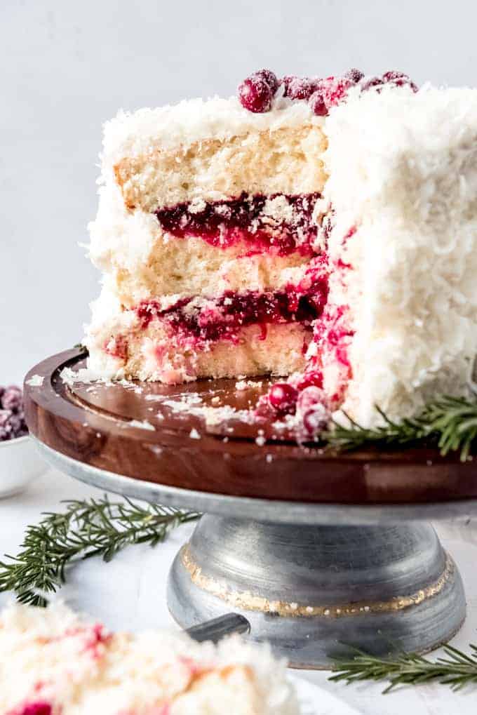 Festive White Cake with Cranberry Filling on a Wooden Stand Festive White Cake with Cranberry Filling on a Wooden Stand — Christmas Dessert Table