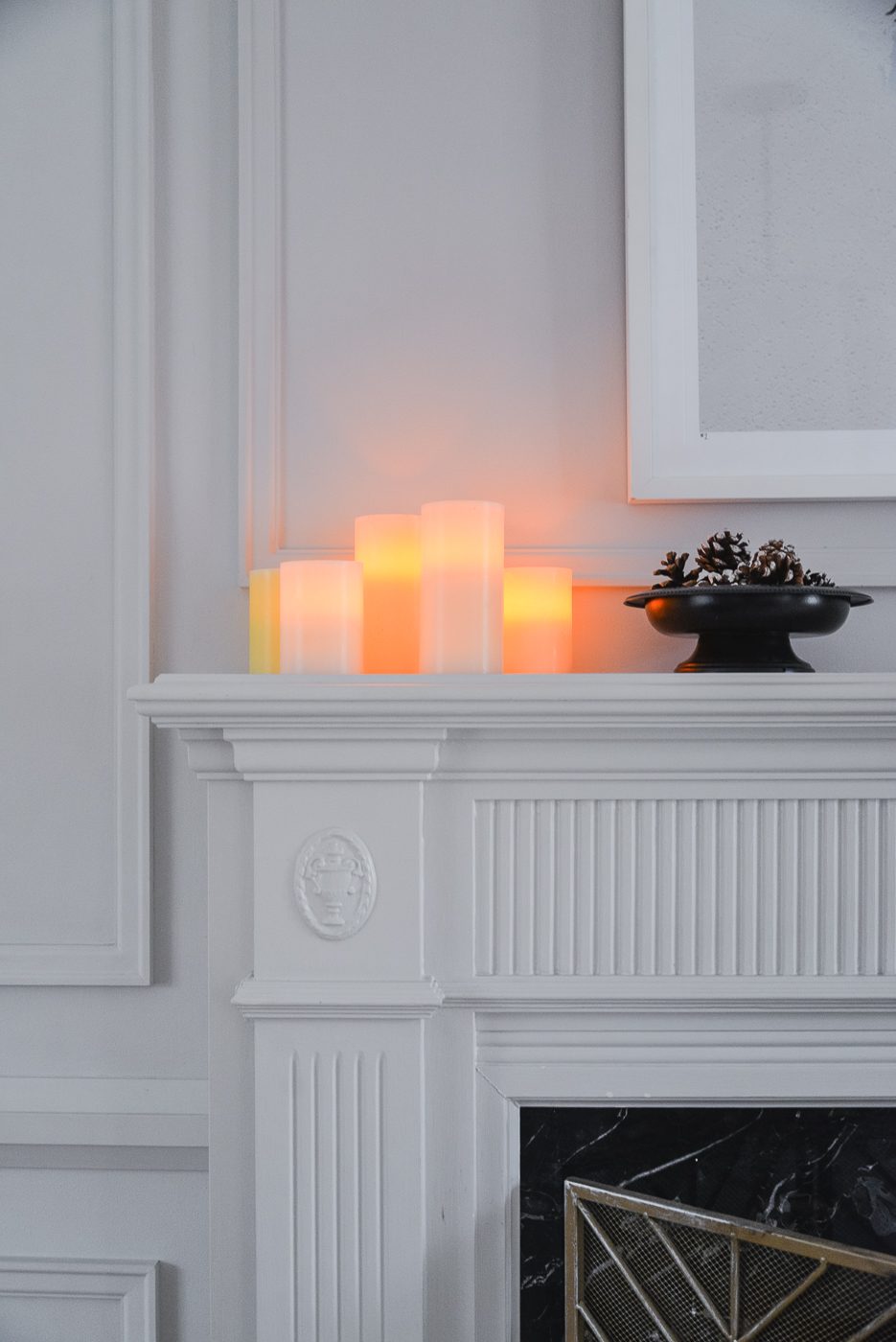 Modern Mantel with Glowing Pillar Candles and Pinecone Arrangement — Winter Decor After Christmas