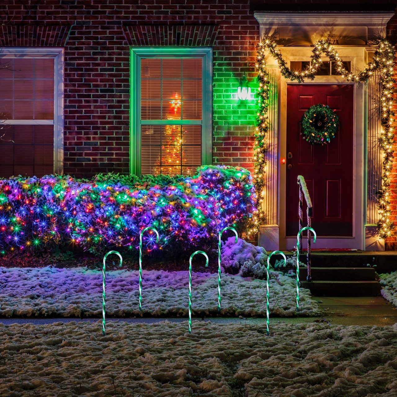Lighted Candy Cane Pathway Markers in a Snowy Yard — Candy Cane Christmas Decor