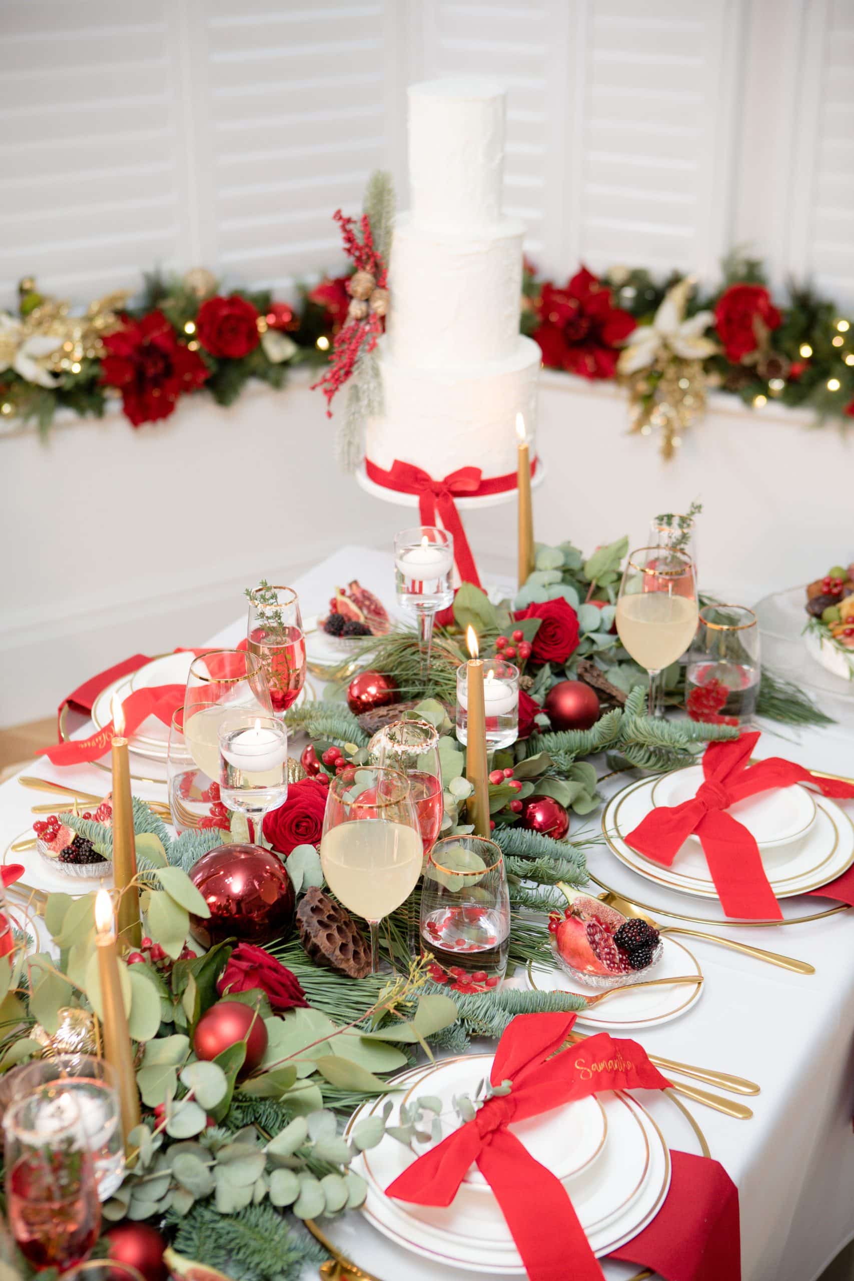 Festive Table Setting with a Tiered Cake and Floral Runner Festive Table Setting with a Tiered Cake and Floral Runner — Christmas Wedding Decor
