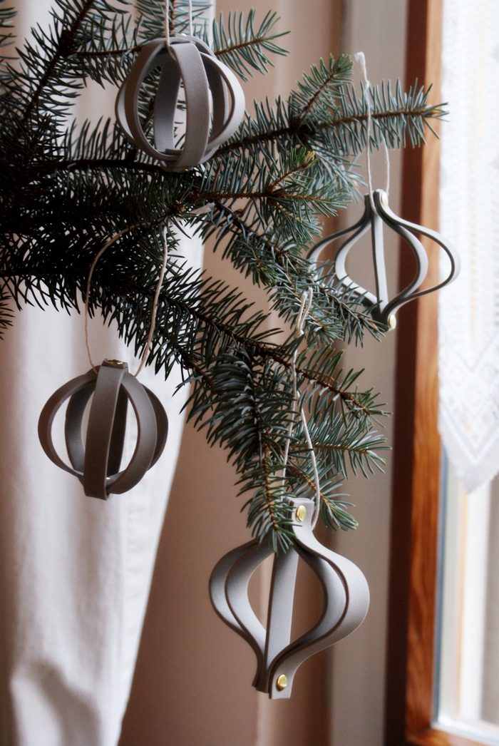 Close-up on Tree Branch with Geometric Grey Leather Ornaments — Minimalist Christmas Tree