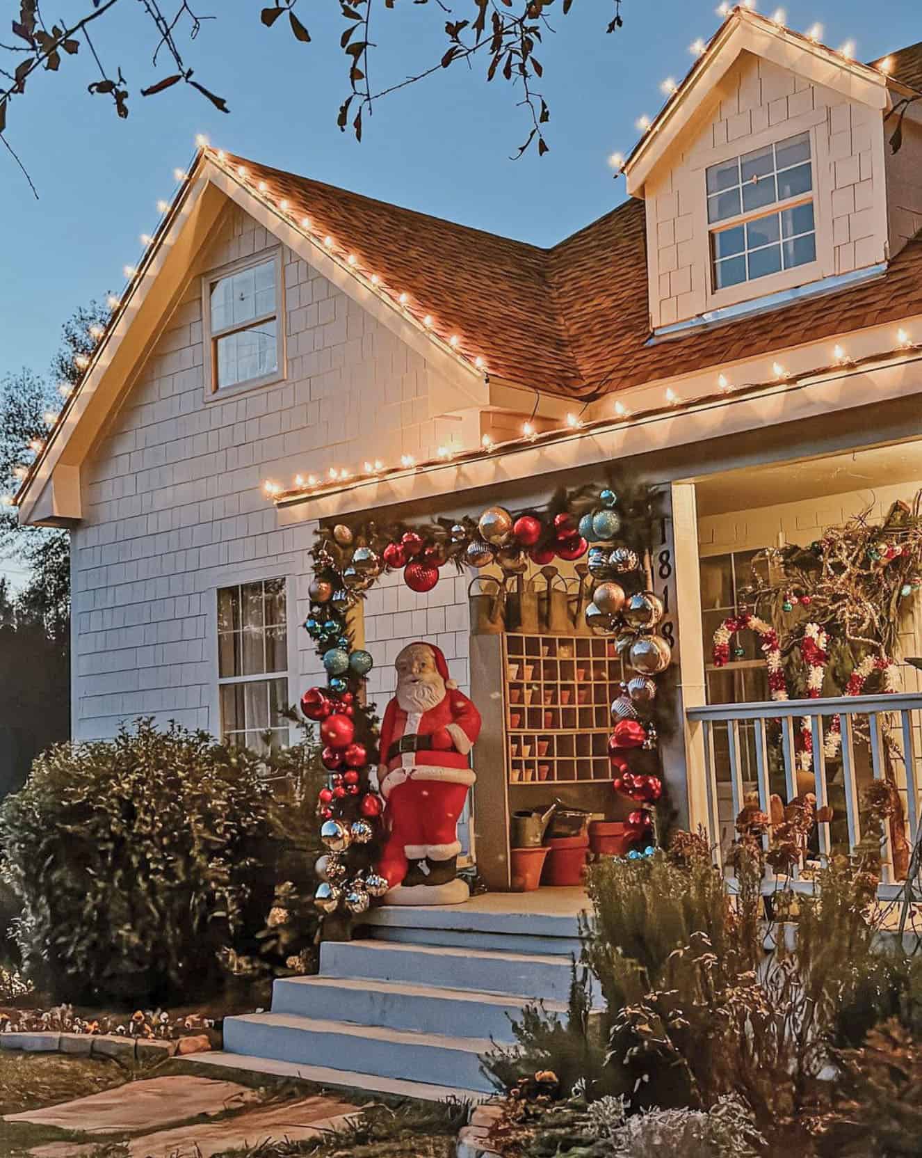 House Exterior with Garland Arch and Santa Statue — Winter Wonderland Christmas Decor