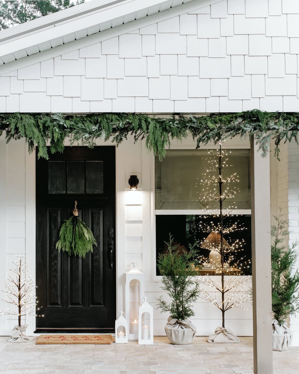Minimalist Farmhouse Porch with Black Door and LED Trees — Farmhouse Christmas Porch