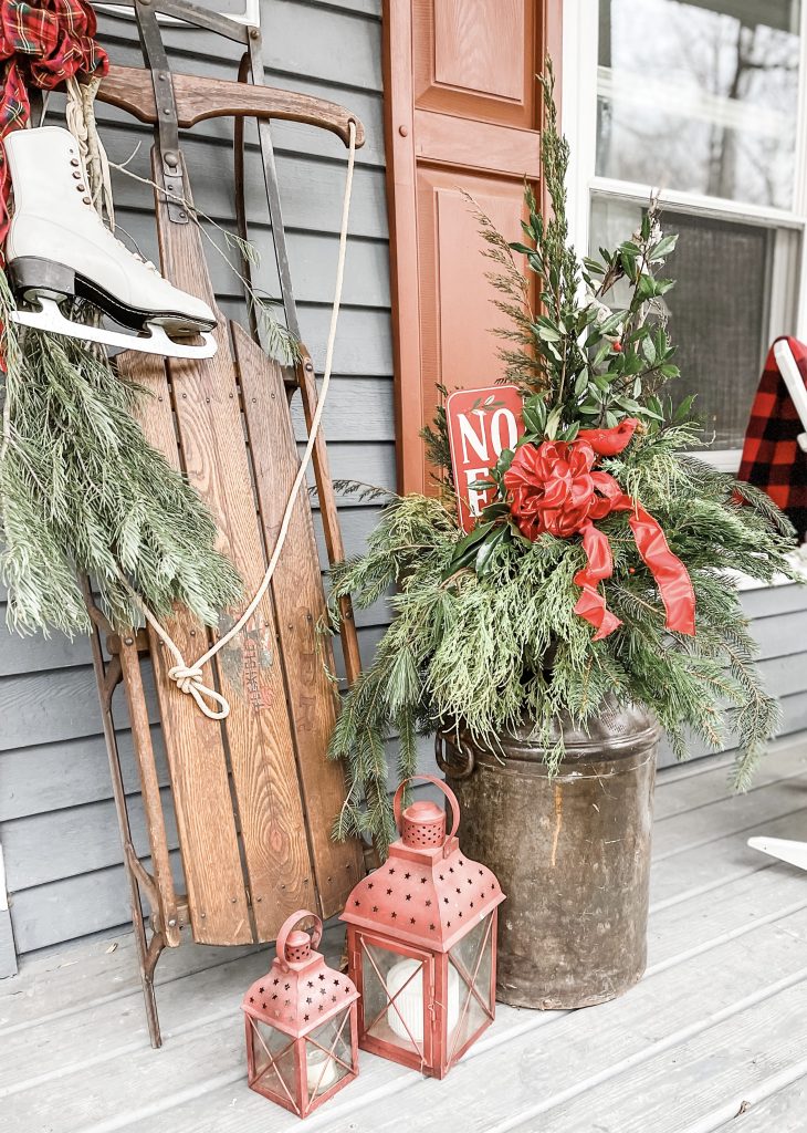 Rustic Metal Planter Paired with Vintage Sled and Lanterns Rustic Metal Planter Paired with Vintage Sled and Lanterns — Christmas Porch Planters