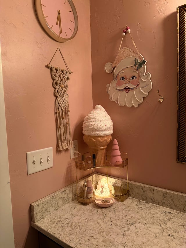 Kitschy Pink Bathroom Corner with Vintage Santa Art — Christmas Bathroom Decor