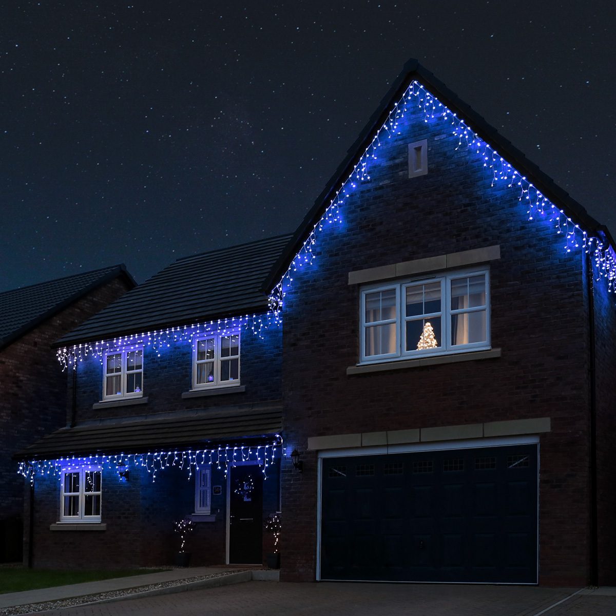 Blue Icicle Lights on Modern Brick House — Icicle Christmas Lights