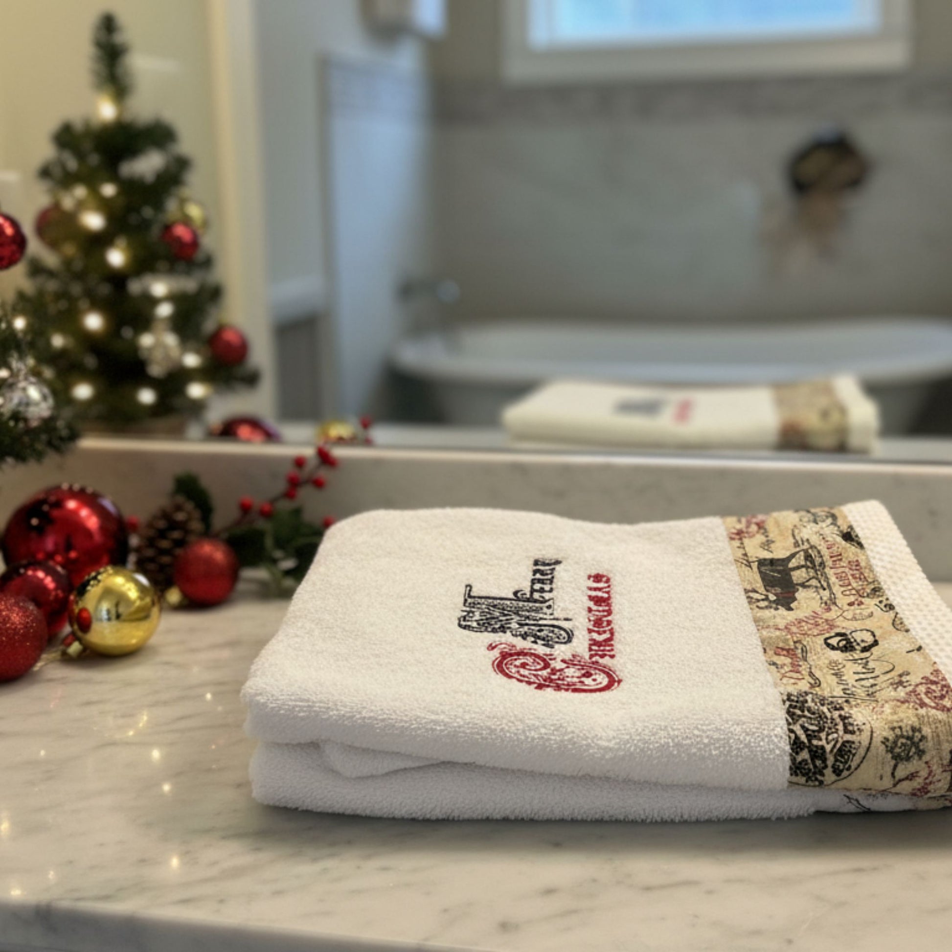 Embroidered Christmas Towels on Marble Countertop — Christmas Bathroom Decor