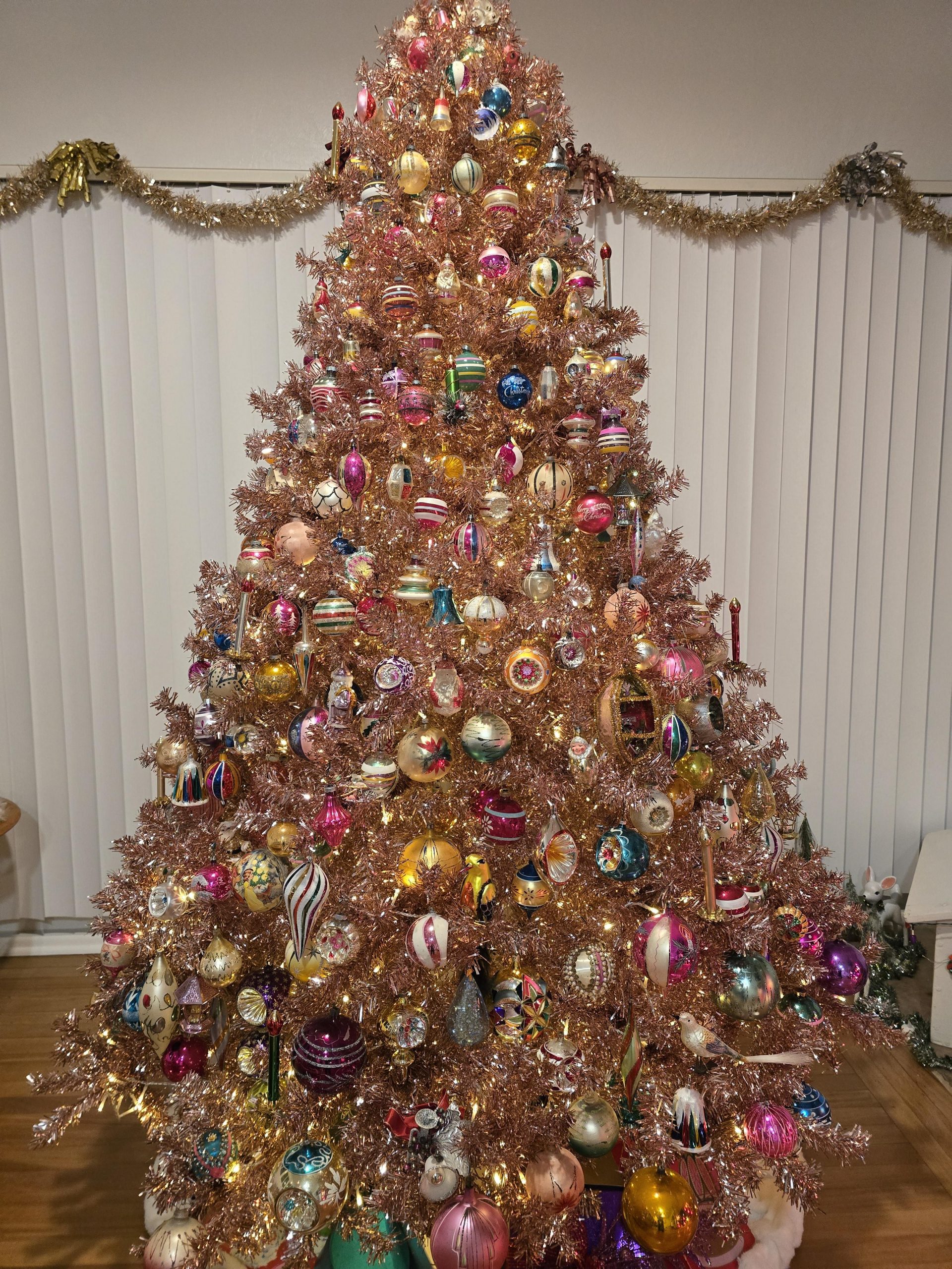 Shimmering Pink Tinsel Tree with Eclectic Ornaments Shimmering Pink Tinsel Tree with Eclectic Ornaments — Pink and Gold Christmas Tree