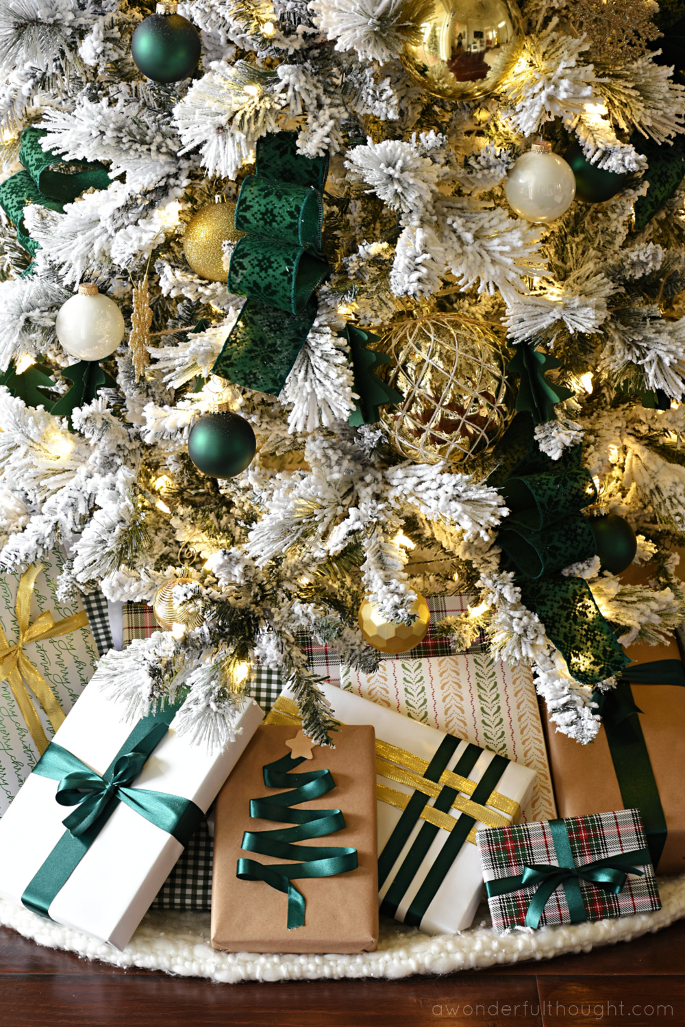 Style a flocked Christmas tree with green ribbon and gold ornaments Style a flocked Christmas tree with green ribbon and gold ornaments — Gold Christmas Decor