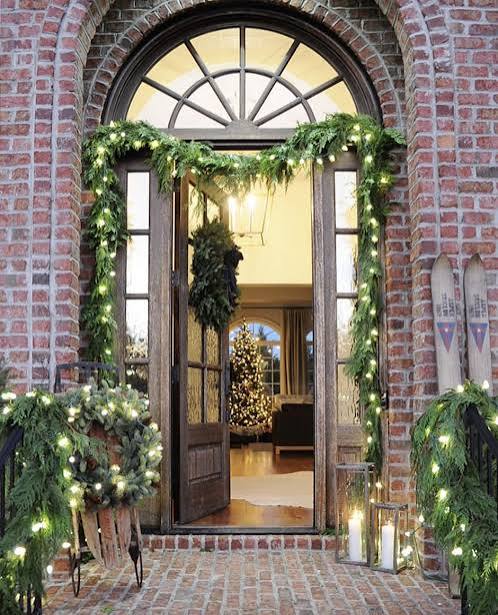 Traditional Entryway Framed by Lush Pine Garland and Lights Traditional Entryway Framed by Lush Pine Garland and Lights — Christmas Wedding Decor