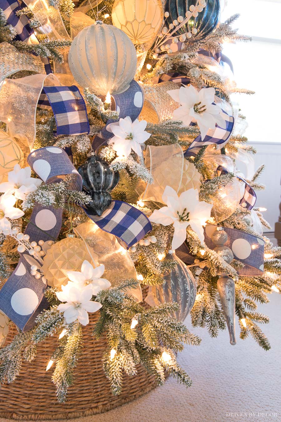 Flocked Tree with Blue Buffalo Check Ribbon and White Poinsettia Ornaments Flocked Tree with Blue Buffalo Check Ribbon and White Poinsettia Ornaments — Ornament Christmas Tree