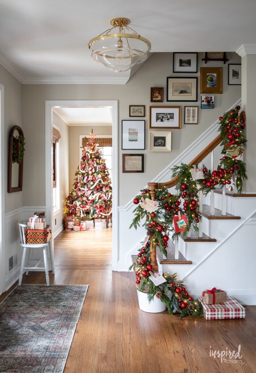 Lush Garland with Red Ornaments and a Nearby Christmas Tree Lush Garland with Red Ornaments and a Nearby Christmas Tree — Christmas Staircase Decor