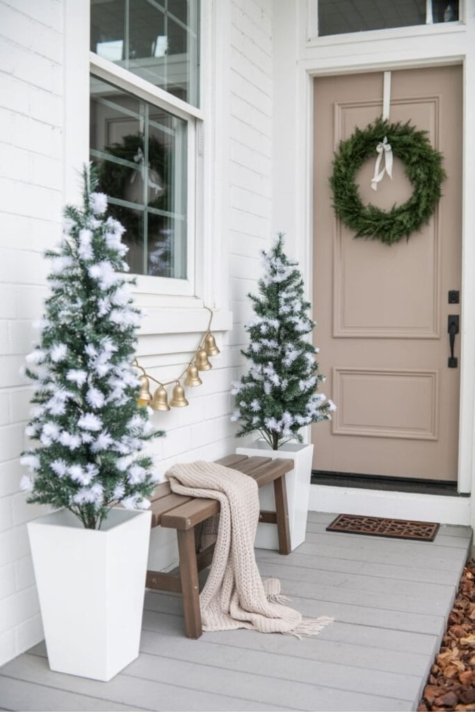 Welcoming Farmhouse Porch with Flocked Trees and Cozy Bench — Farmhouse Christmas Porch