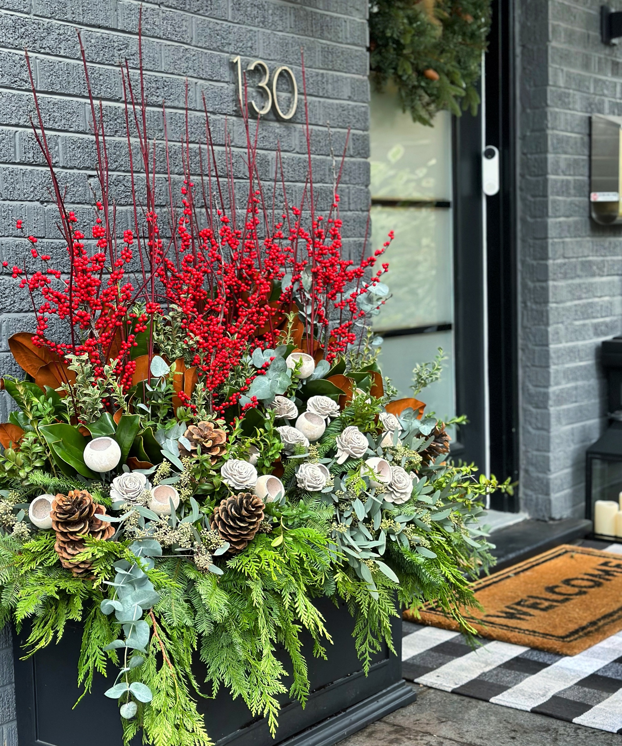 Modern Planter Overflowing with Red Berries and Magnolia Leaves Modern Planter Overflowing with Red Berries and Magnolia Leaves — Christmas Porch Planters