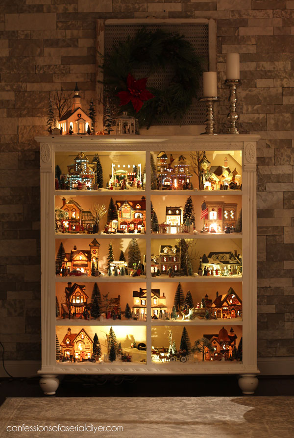 Extensive Christmas Village Display within a White Cabinet