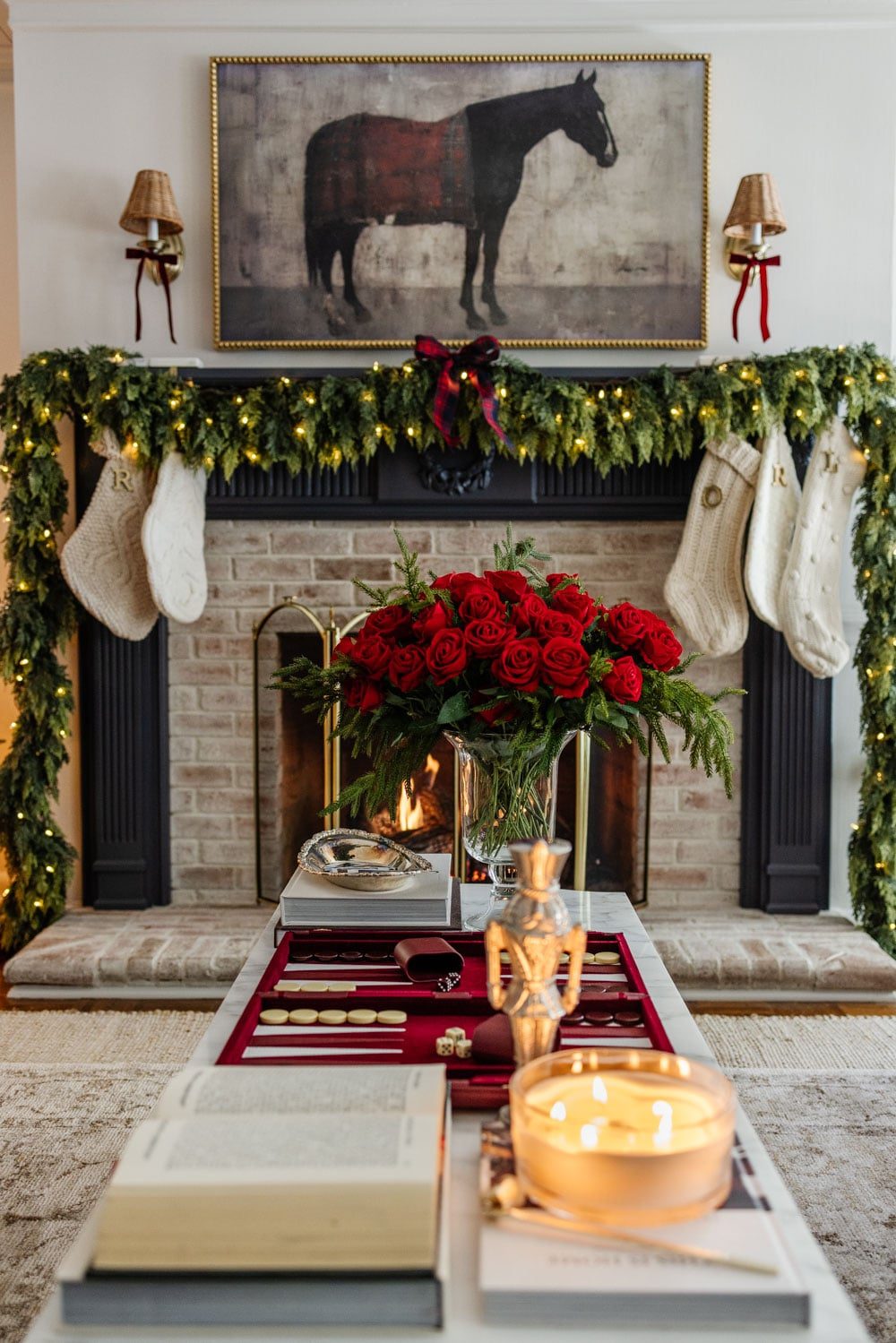 Festive Fireplace Mantel with Green Garland and Red Roses Festive Fireplace Mantel with Green Garland and Red Roses — Christmas Decor