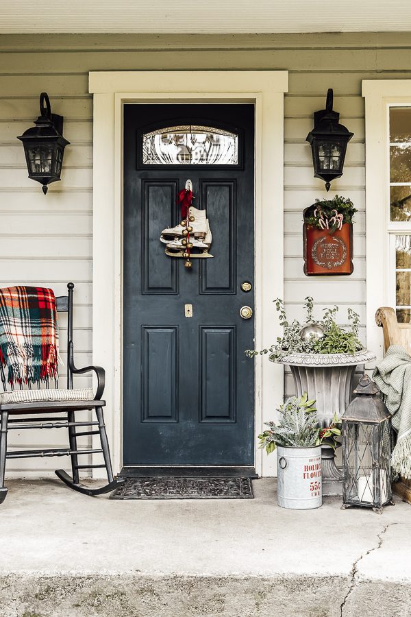 Farmhouse Porch with Ice Skate Wreath and Plaid Accents — Christmas Porch Decor