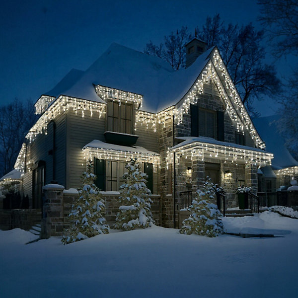 Elegant Icicle Lights on a Stone House Roofline — Icicle Christmas Lights
