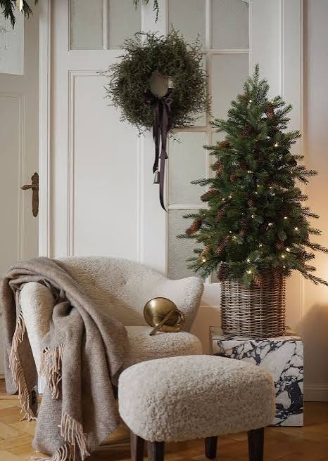 Cozy Modern Seating Area with Textured Armchair and Christmas Tree — Modern Christmas Decor