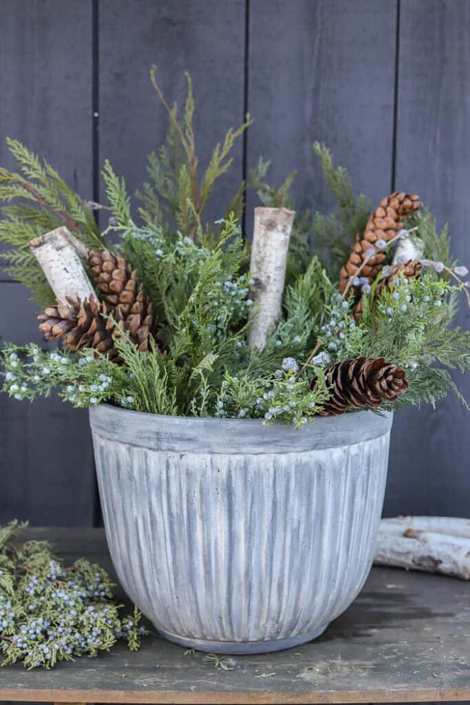 Textured Concrete Planter with Natural Winter Elements Textured Concrete Planter with Natural Winter Elements — Christmas Porch Planters