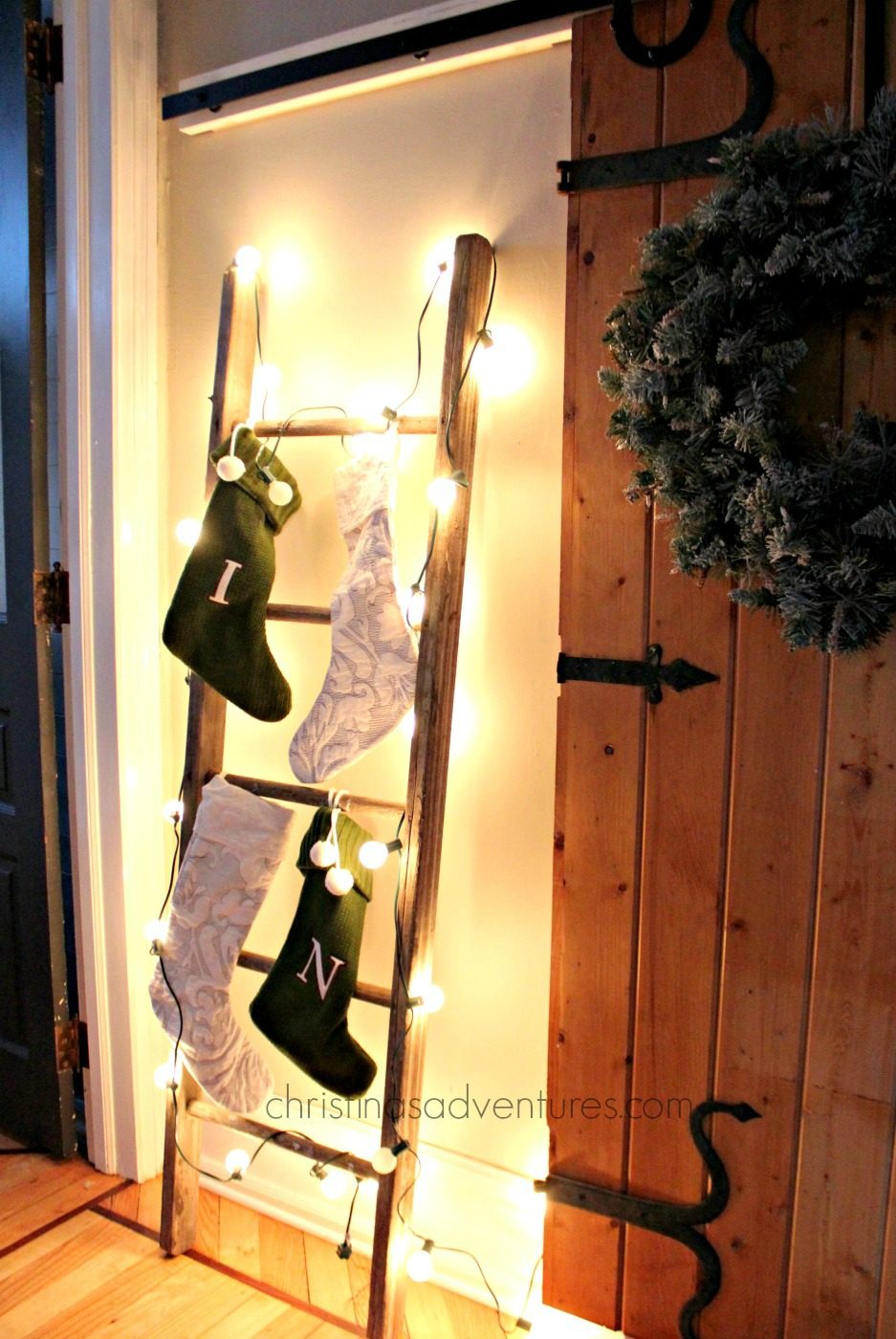 Rustic Ladder with Fairy Light-Draped Stockings — Christmas Stockings Display