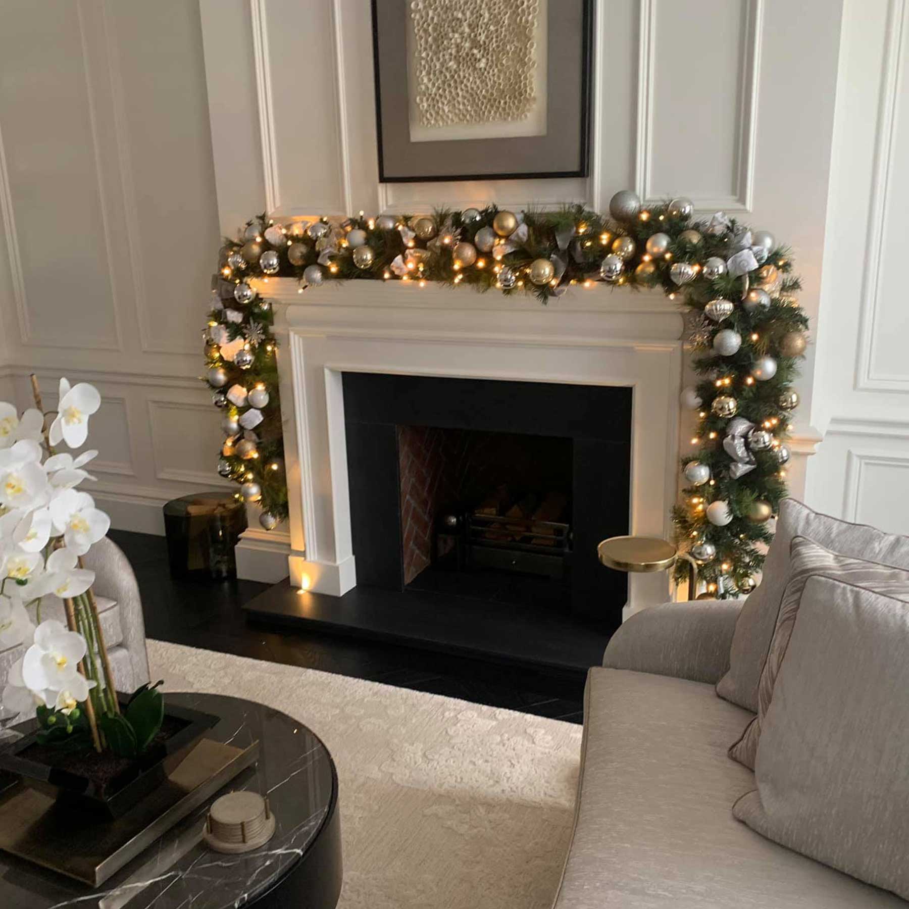 Elegant Garland with Ornaments and Ribbon on Fireplace Elegant Garland with Ornaments and Ribbon on Fireplace — Christmas Lights in Garland Indoor