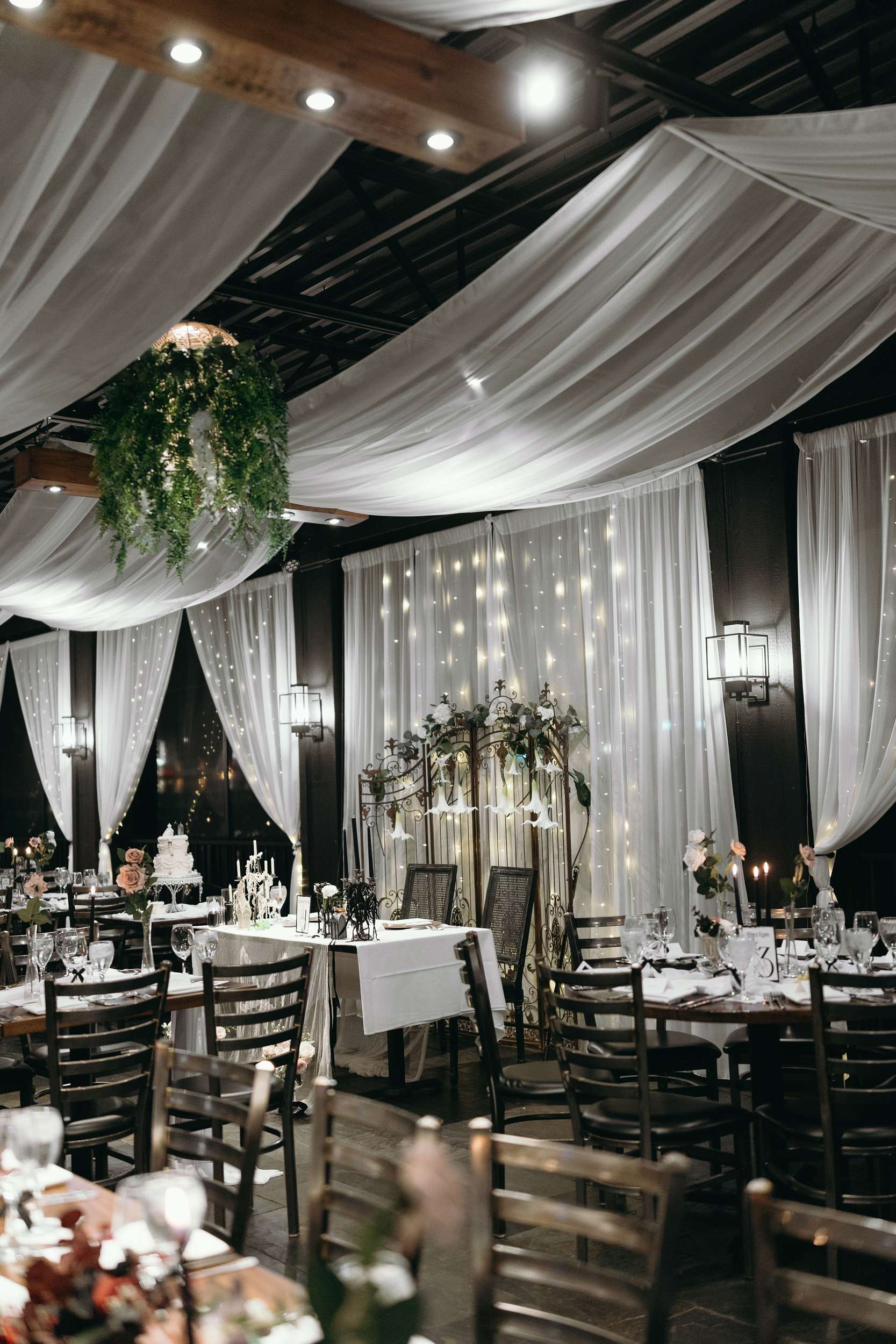Magical Reception Hall with Draped Fabric and Fairy Lights Magical Reception Hall with Draped Fabric and Fairy Lights — Christmas Wedding Decor