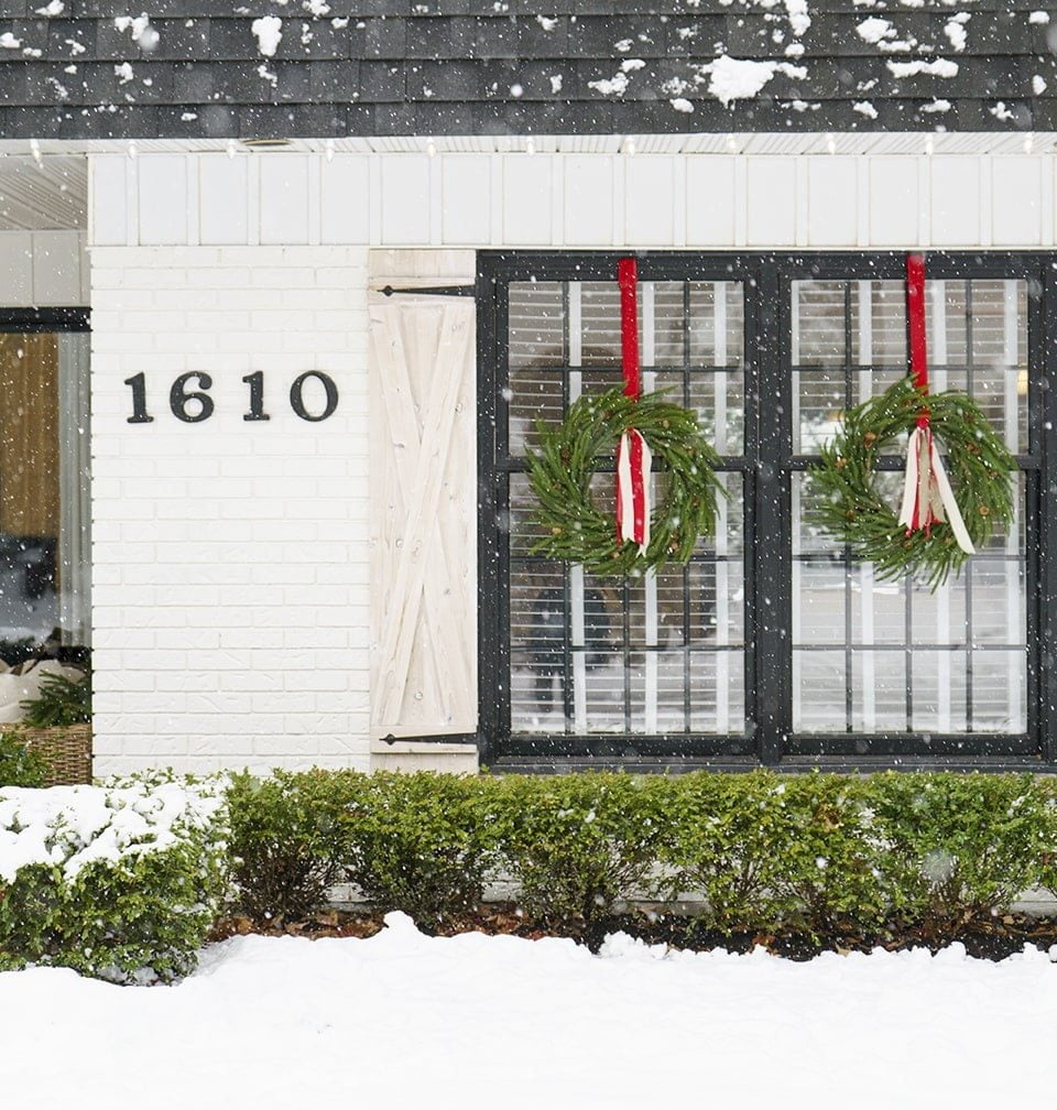 Symmetrical Modern Farmhouse Wreaths on Black-Framed Window — Christmas Window Wreaths
