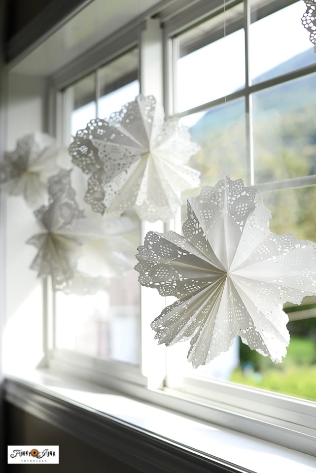 Delicate Doily Paper Snowflakes in a Window
