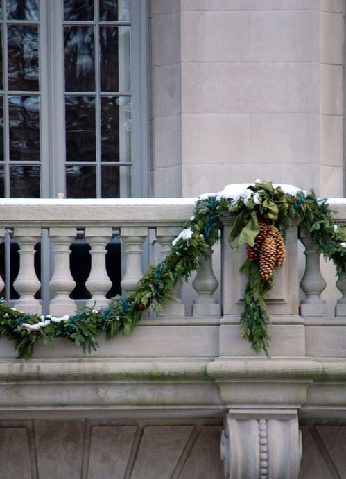 Traditional Stone Balustrade with Evergreen Garland and Pinecones Traditional Stone Balustrade with Evergreen Garland and Pinecones — Christmas Balcony Decor