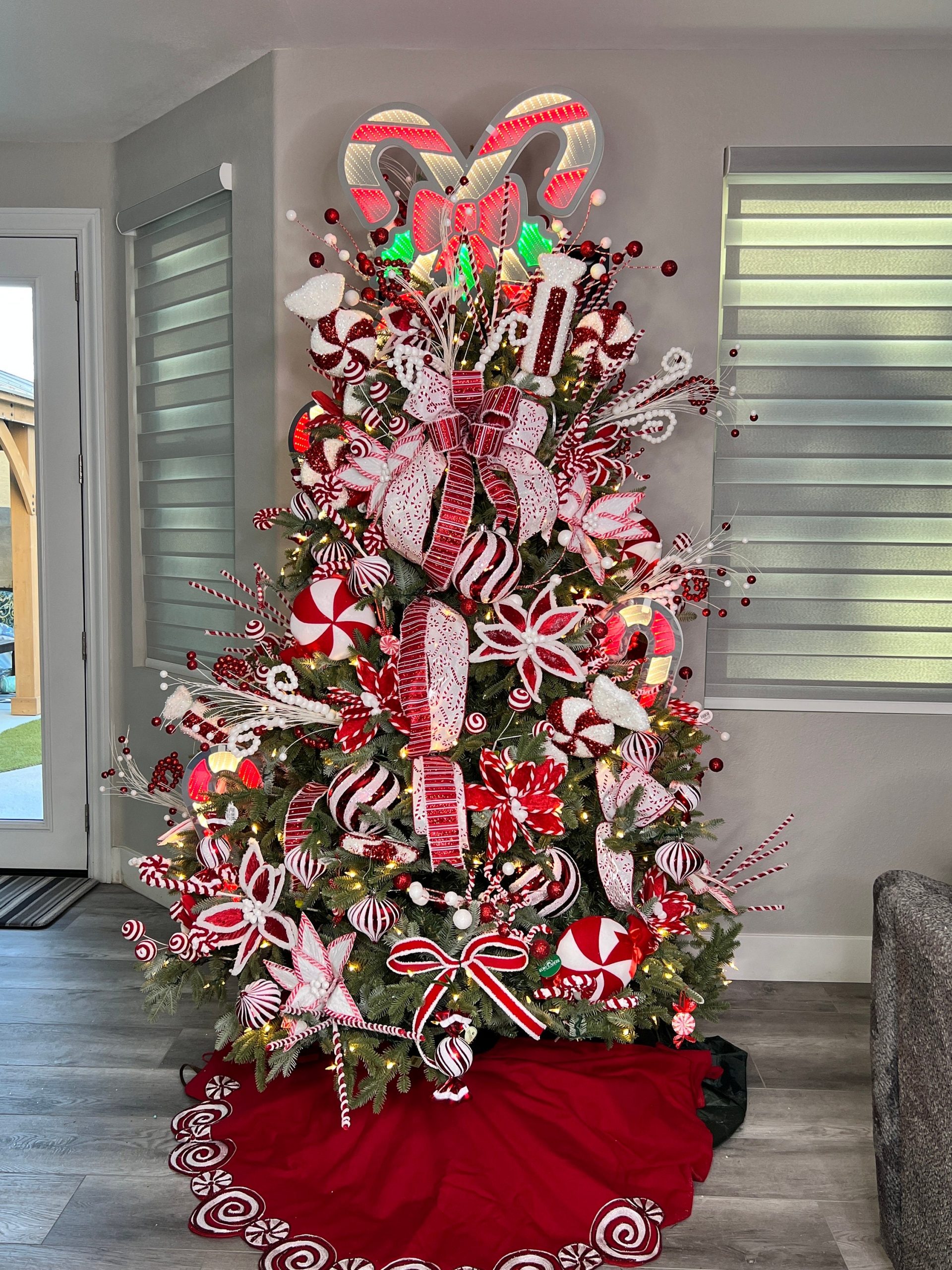 Whimsical Candy Cane Christmas Tree with Abundant Themed Ornaments