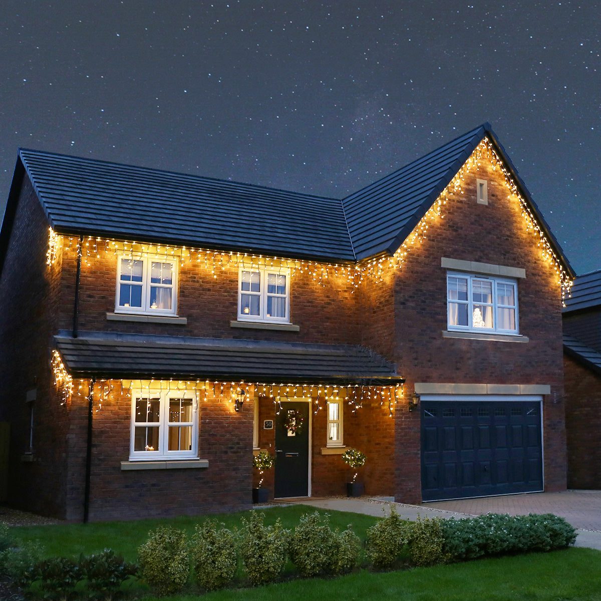 Warm White Icicle Lights on Two-Story Brick House — Icicle Christmas Lights