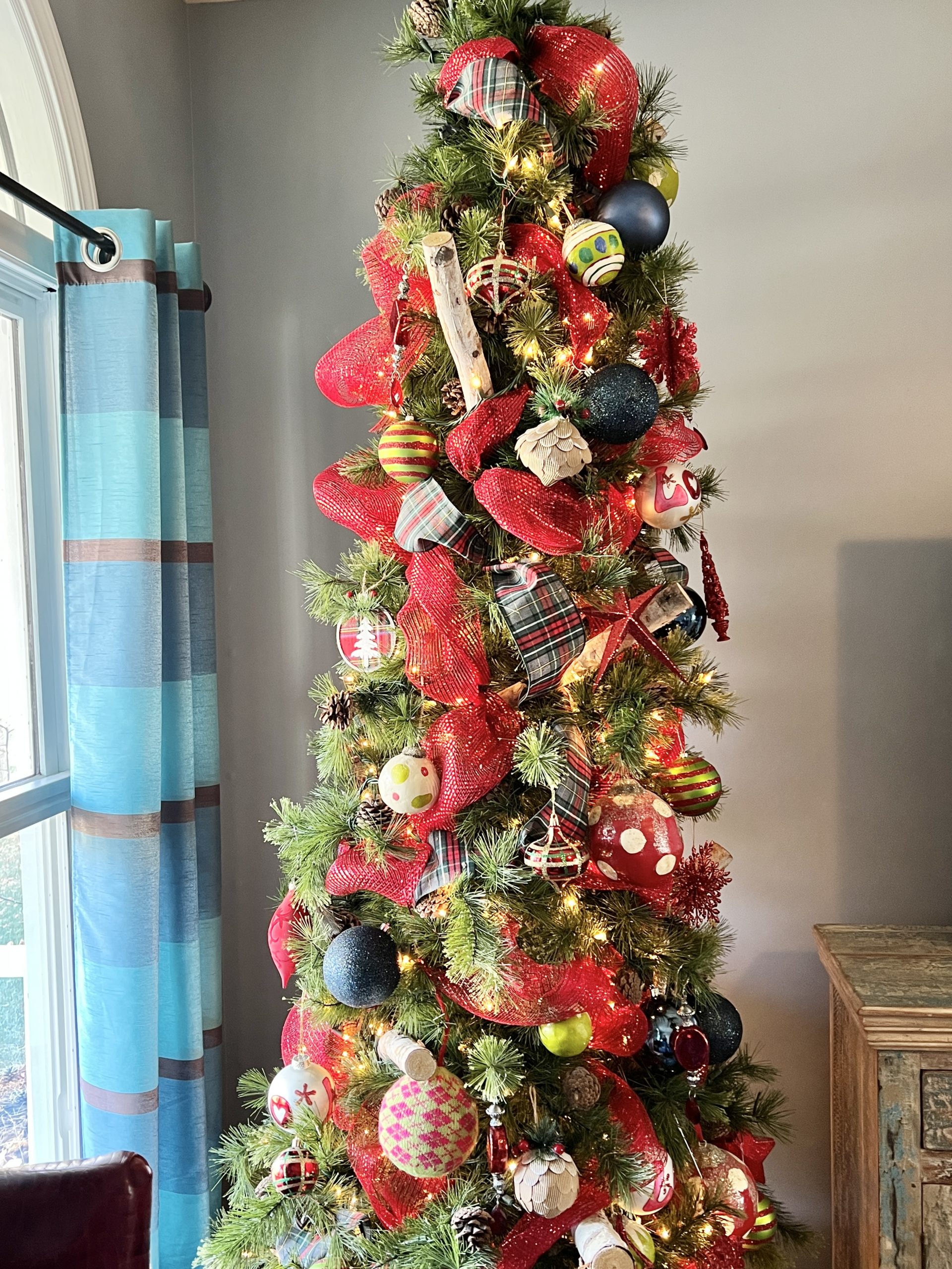Traditional Slim Tree with Red Plaid Ribbon and Blue Curtains — Slim Christmas Tree Decor
