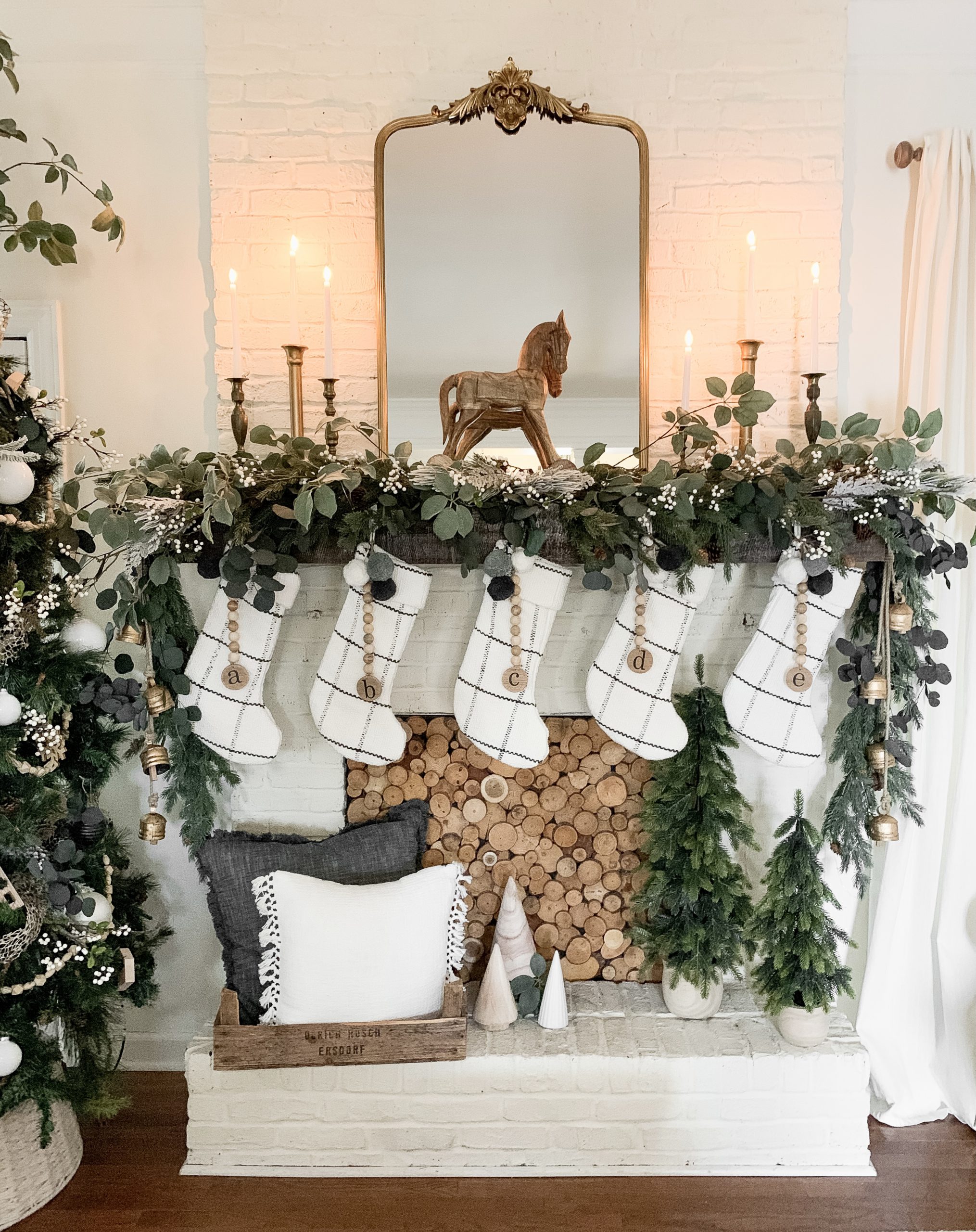 Farmhouse Fireplace Mantel with White Christmas Stockings and Garland Farmhouse Fireplace Mantel with White Christmas Stockings and Garland — White Christmas Decor