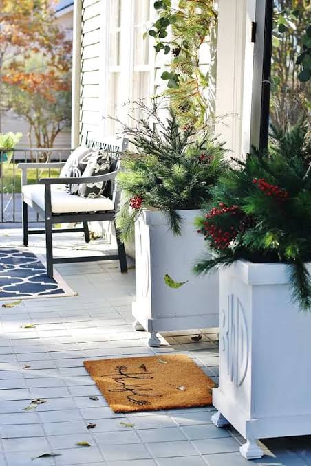 Large White Planters Complementing a Cozy Porch Scene Large White Planters Complementing a Cozy Porch Scene — Christmas Porch Planters