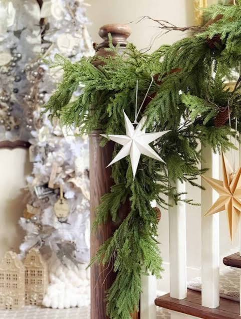 Lush Garland with Paper Star Ornaments on a Staircase Lush Garland with Paper Star Ornaments on a Staircase — Christmas Garland