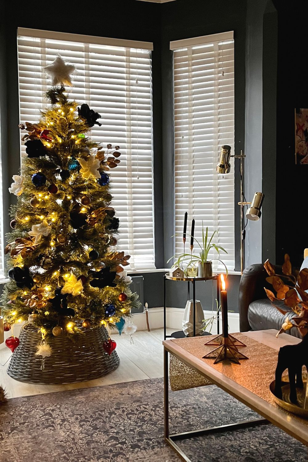 Dimly Lit Modern Living Room Corner with Wicker Christmas Tree Skirt — Modern Christmas Decor