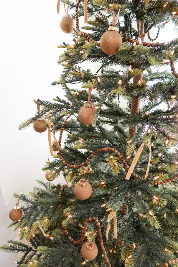 Close-up Detail of a Neutral Christmas Tree with Wooden Beads